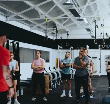Members and coach talking at Temple Fitness