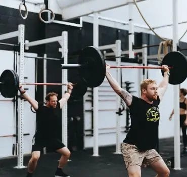 Men lifting heavy weights at Temple Fitness